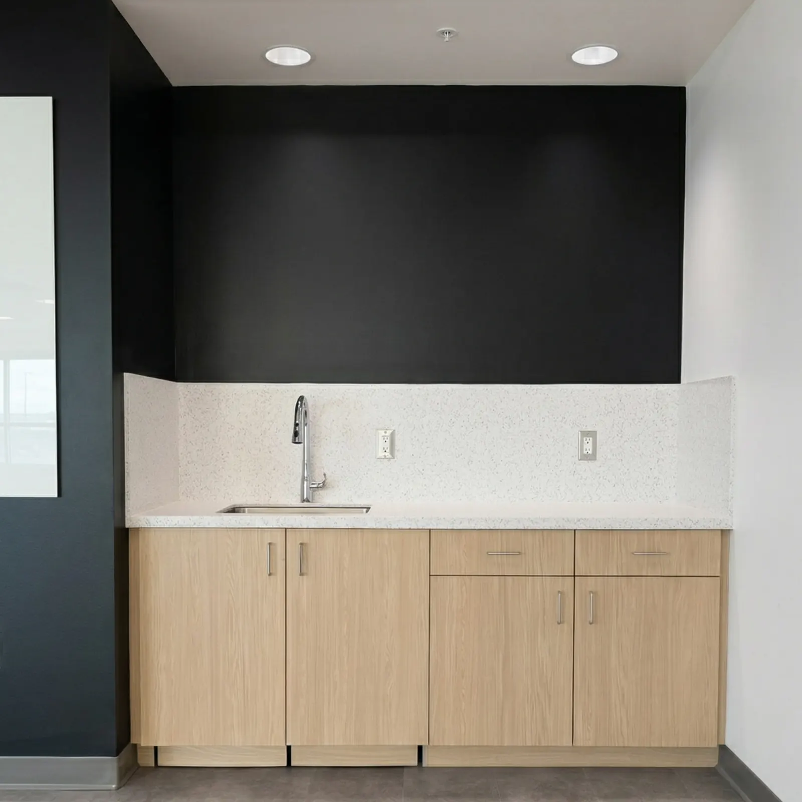 Maintenance facility sink station with Wilsonart Avalanche Melange countertop and backsplash with Formica Aged Ash HPL cabinets in Port Hueneme CA
