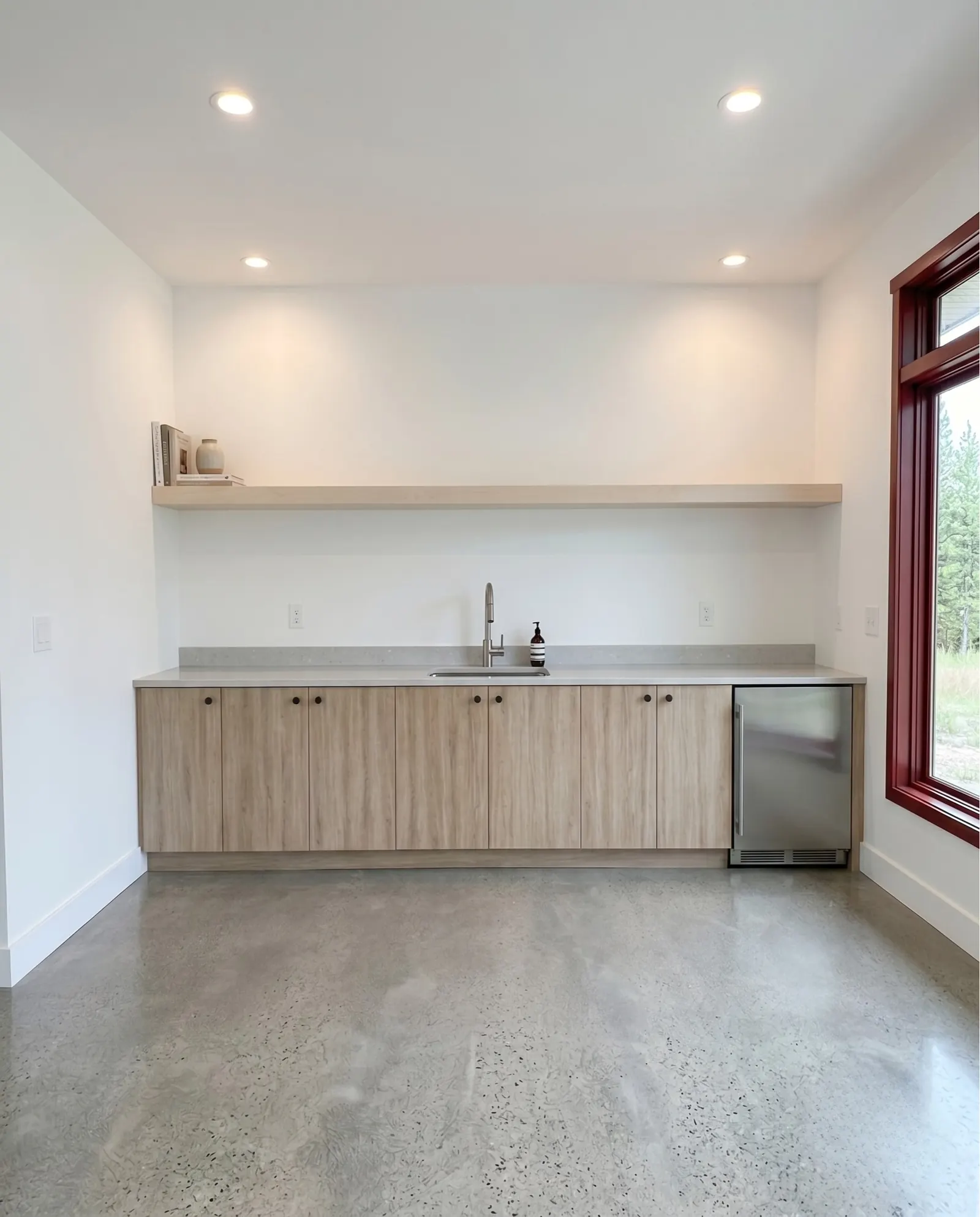 Detailed view of light maple wood veneer millwork columns and wall paneling in apartment complex seating niche in Goleta CA