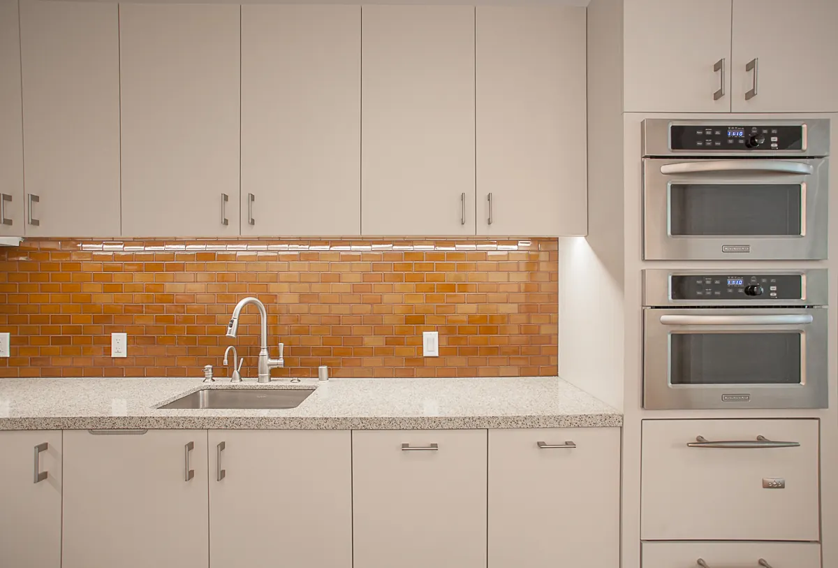 Medical office kitchen cabinetry with countertops and tile backsplash in Pasadena CA healthcare facility